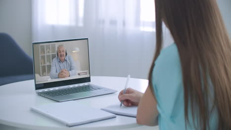 distance-teacher-online-tutor-conferencing-on-laptop-communicate-with-pupil-by-webcam-video-call-e-learning.-Home-quarantine-distance-learning-and-working-at-home.